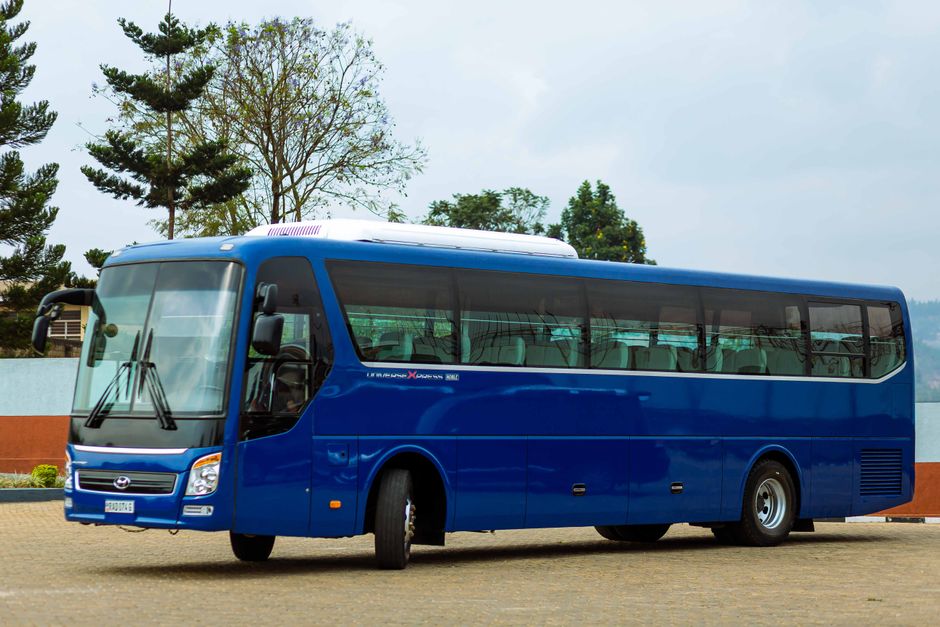 A 60-passenger charter bus parked and ready to board a large travel group