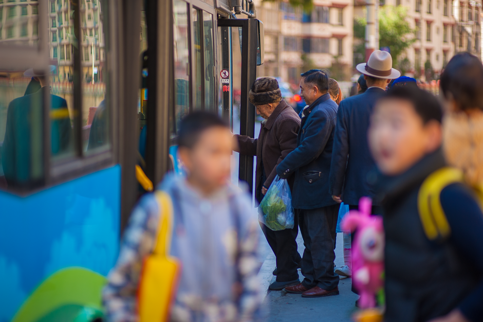 A family with children boarding a charter bus for a group vacation trip