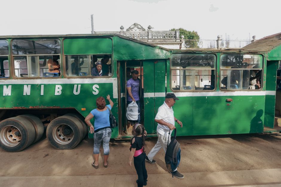 A full-size 45-passenger charter bus parked and ready for group boarding