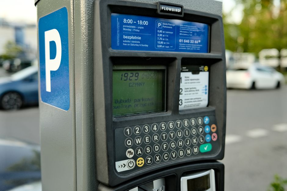 A parking lot ticket machine representing who pays for parking fees in rentals and group travel