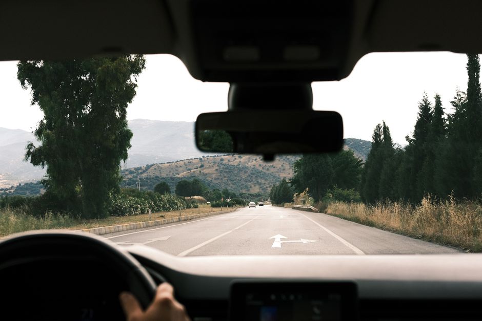 Charter bus driver behind the wheel on a highway during a long-distance trip