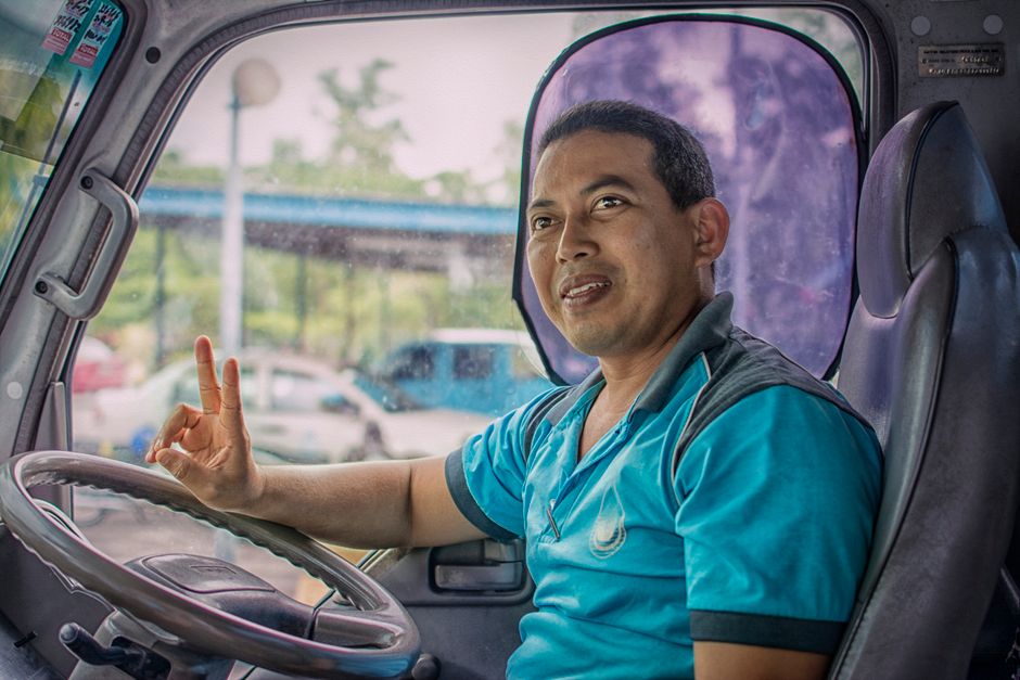 Charter bus driver checking safety credentials before a group trip departure