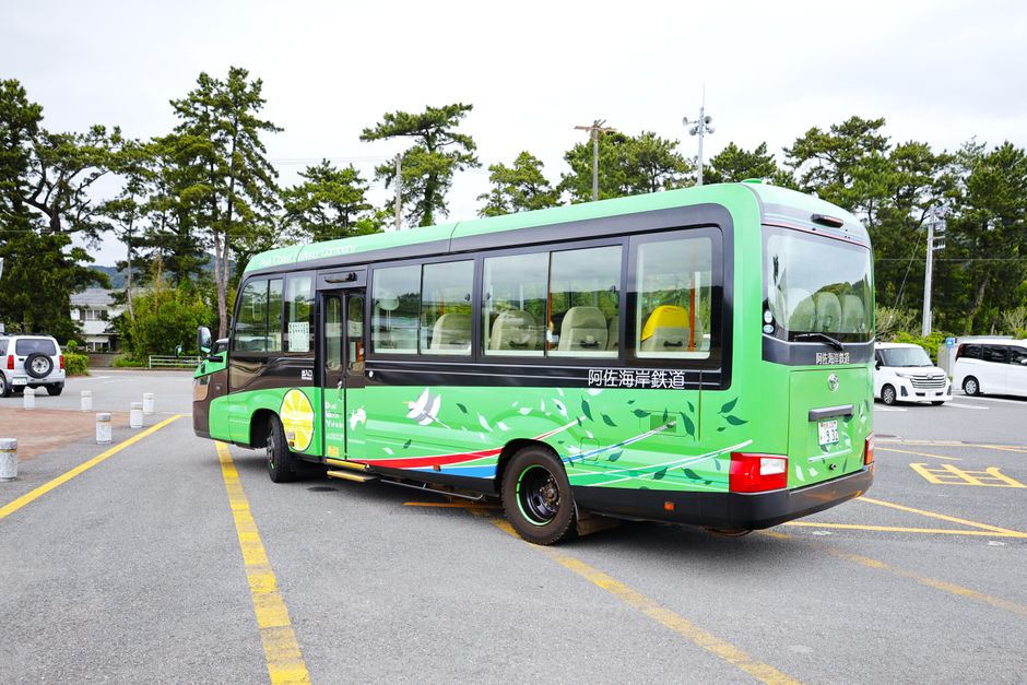 Charter bus parked at a busy terminal during peak travel season with passengers boarding