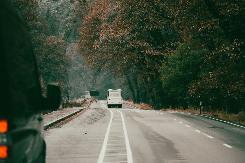 Charter bus parked on a highway representing factors that affect charter bus rental prices