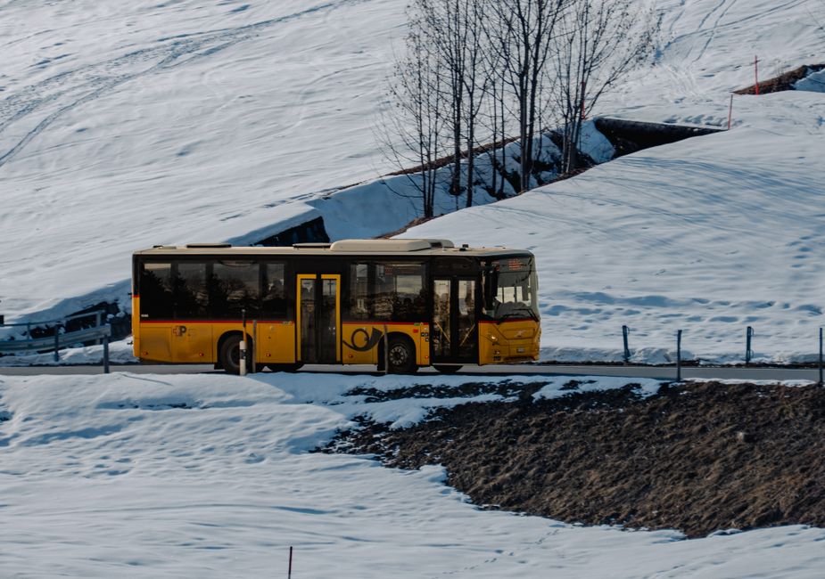 Charter bus parked outside in snowy winter weather with passengers boarding