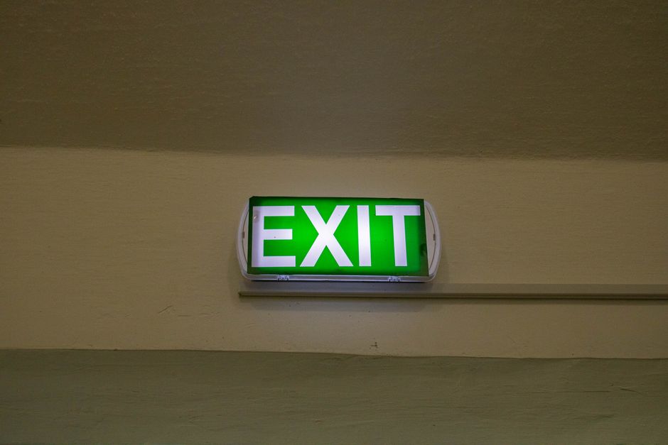 Charter bus parked with emergency exit signage visible for passenger safety