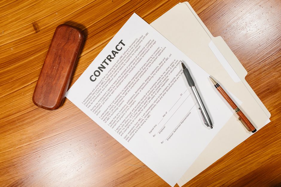 Group leader reviewing a charter bus refund and cancellation policy contract