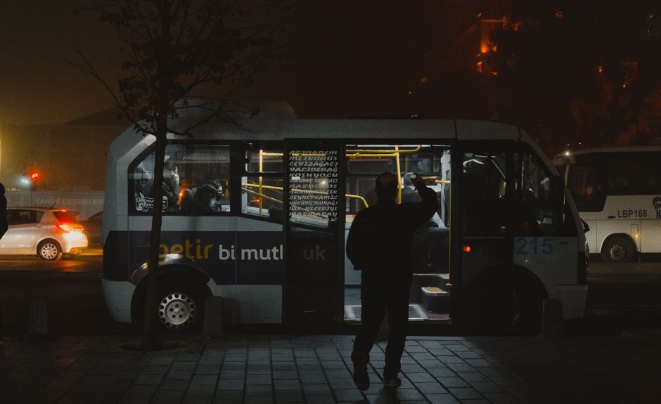 Group of 35 passengers boarding a mid-size charter bus for a group trip