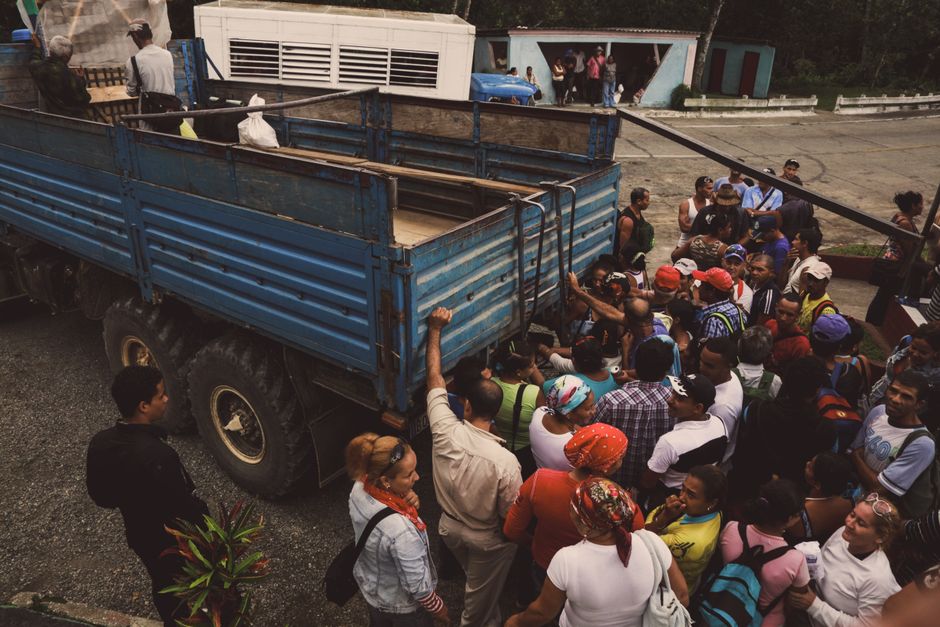 Group of passengers politely boarding a charter bus while following proper etiquette