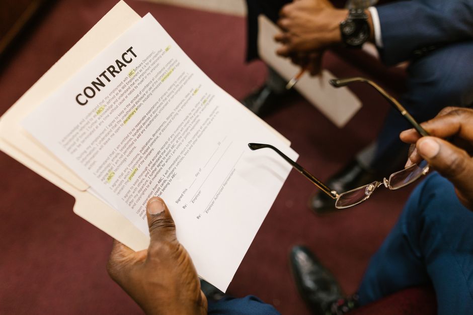 Group organizer reviewing and signing a charter bus rental contract