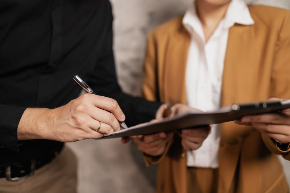 Group travel organizer reviewing a charter bus deposit and cancellation policy contract