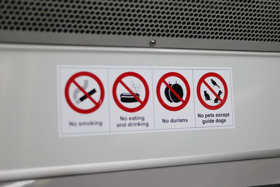 No smoking sign displayed near the entrance of a charter bus