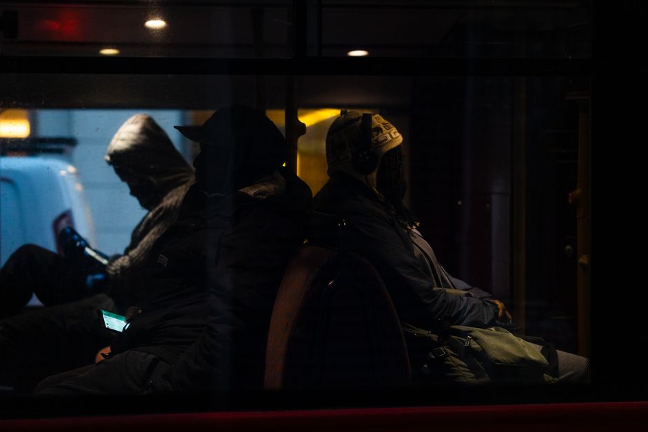 Passengers enjoying entertainment features on a charter bus during a group trip