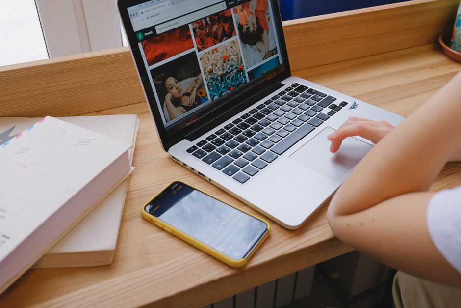 Person using a laptop to book a charter bus online through a quote request form