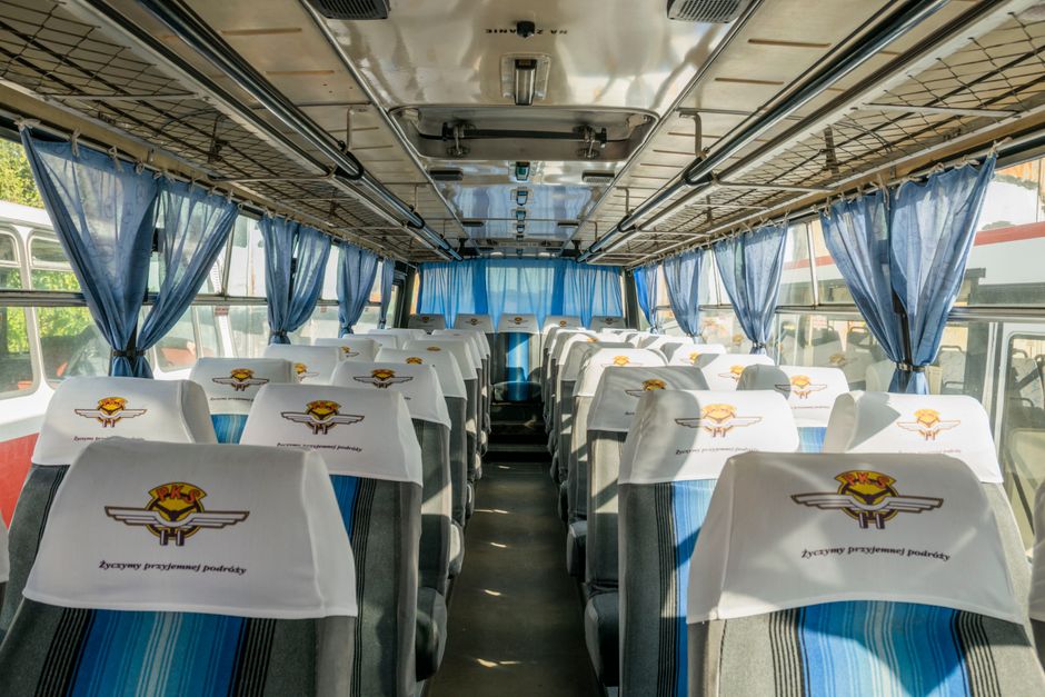 Rows of comfortable reclining seats inside a charter bus