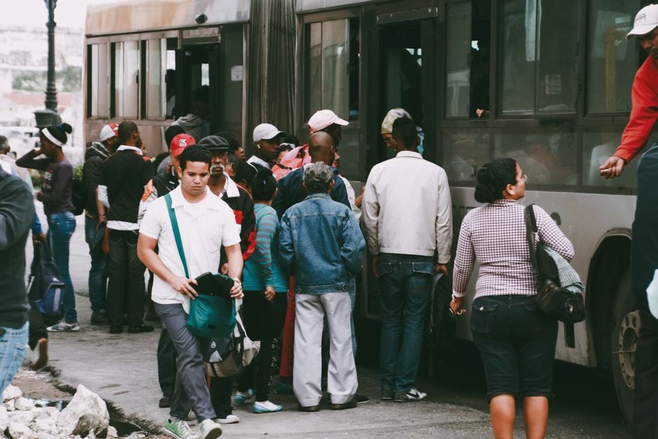 Small group of travelers boarding a mini charter bus for a group trip