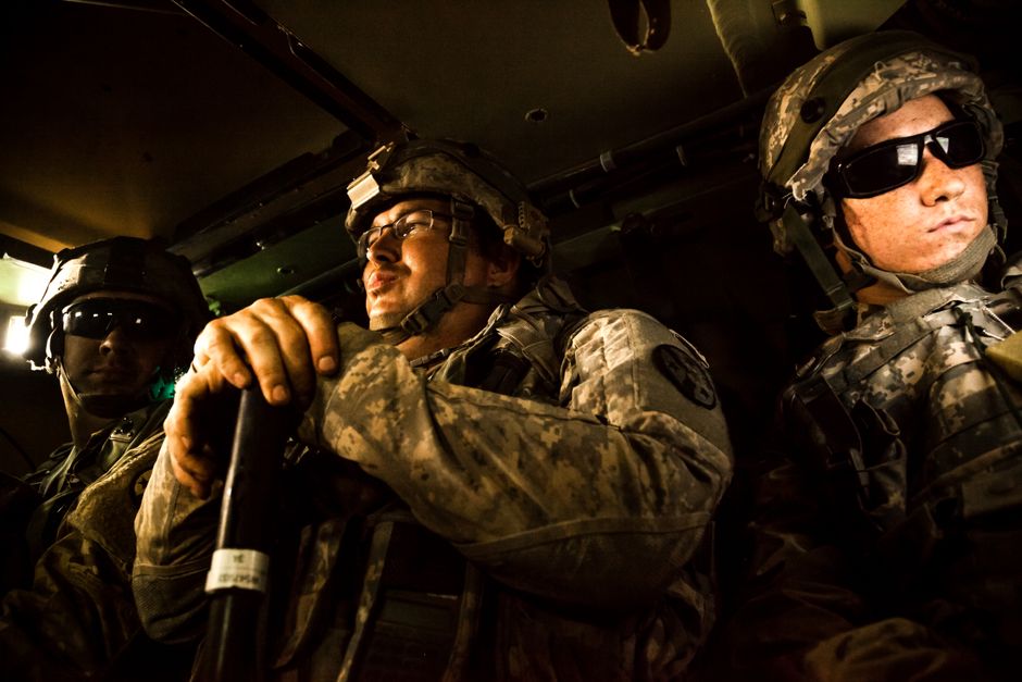 Soldiers boarding a charter bus for military group transportation at a base