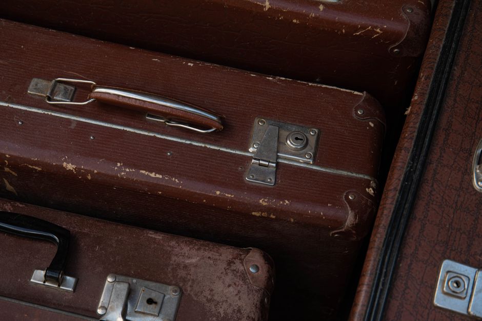 Suitcases being loaded into the underneath storage compartment of a charter bus