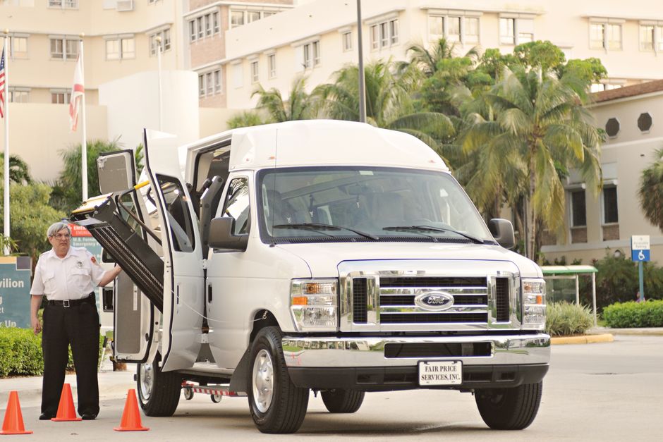 Wheelchair lift deployed at the door of an accessible charter bus for boarding