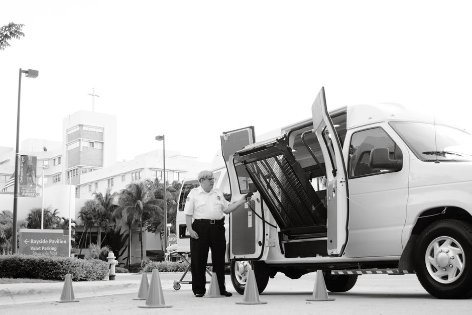 Wheelchair user boarding a charter bus using an accessible lift