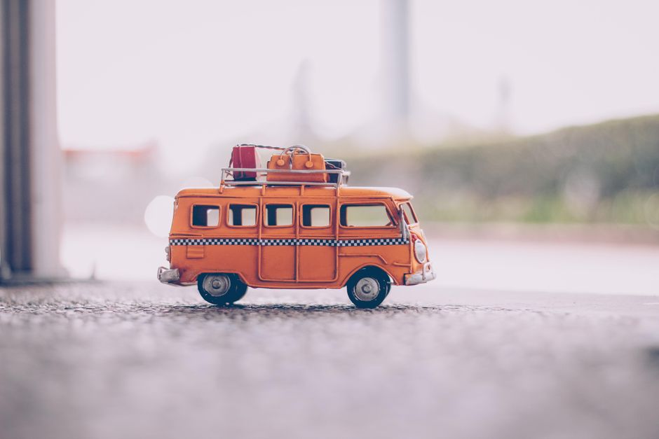 White mini bus parked outside ready for a group rental trip