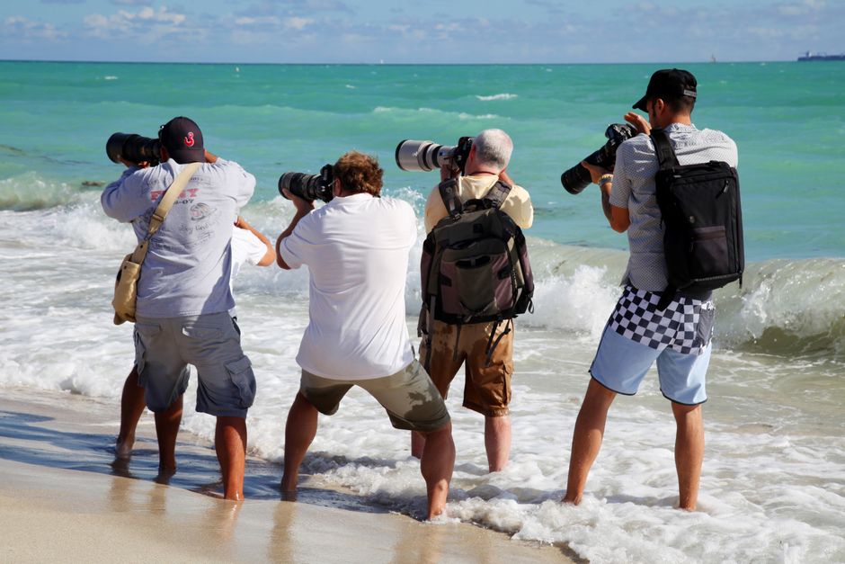 A charter bus parked near a scenic Florida beach with palm trees, used for group travel
