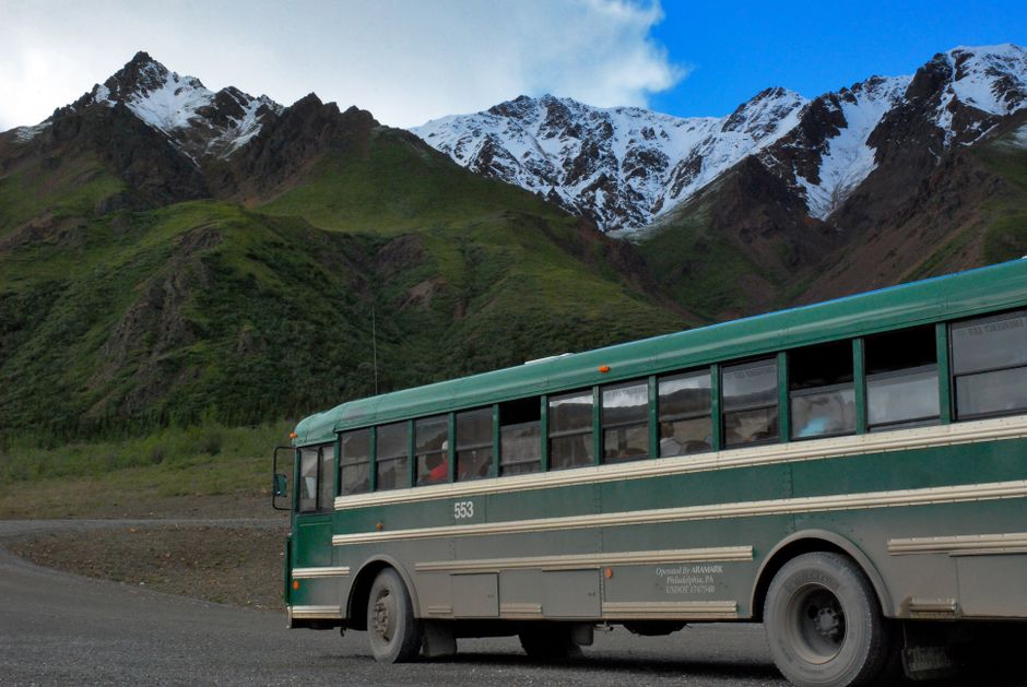 A charter bus traveling on a scenic mountain highway during a weekend trip from Atlanta