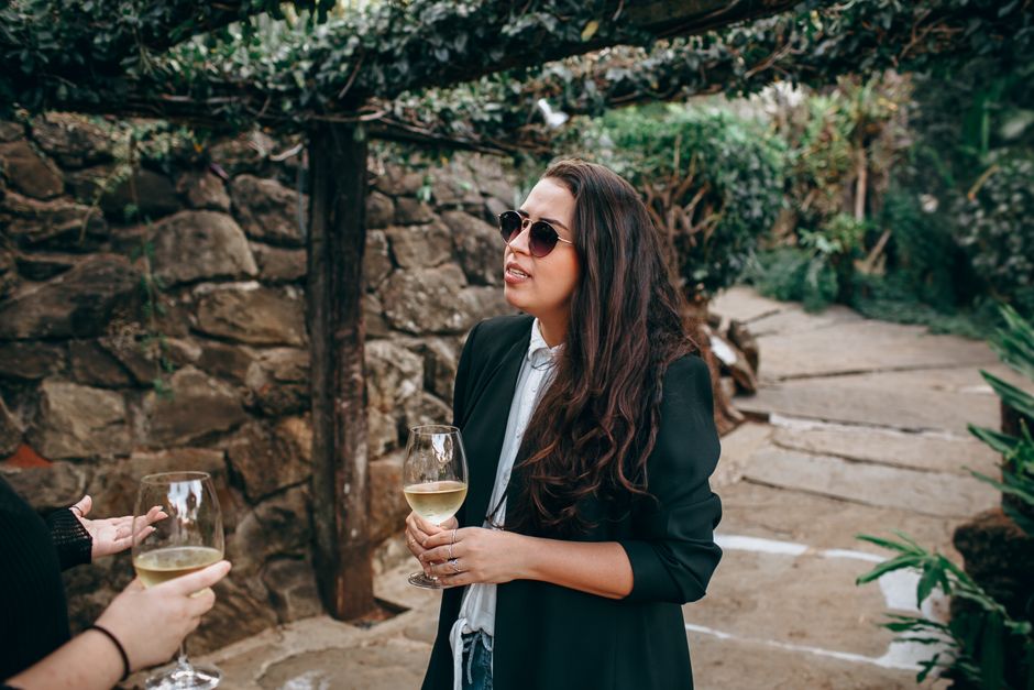 A group of friends enjoying wine tasting together at a vineyard during a weekend wine tour