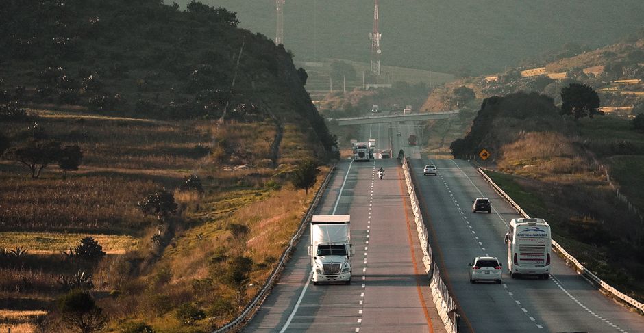 Charter bus driving along a scenic southern highway during a large group road trip