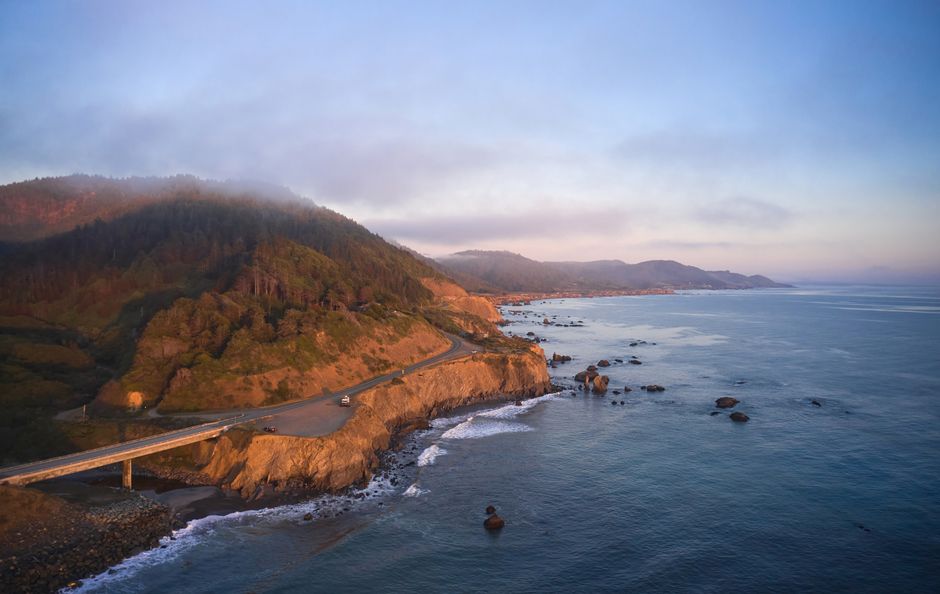 Charter bus traveling along a scenic California highway for a group getaway from Los Angeles