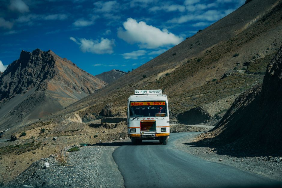 Charter bus traveling on a scenic mountain highway during a weekend group trip from Atlanta