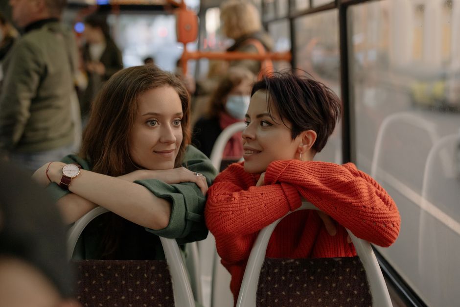 Group of friends splitting the cost of a charter bus rental before boarding for a trip