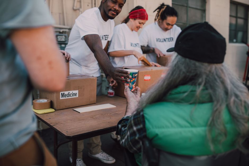 Nonprofit volunteers boarding a charter bus after securing a discounted group rental rate