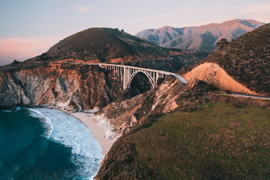 Scenic coastal highway winding along the California coastline, ideal for a group road trip