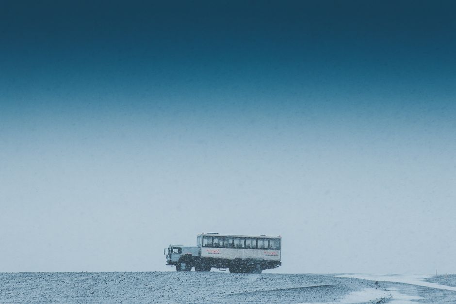 Charter bus traveling on a quiet road during the off-season winter months