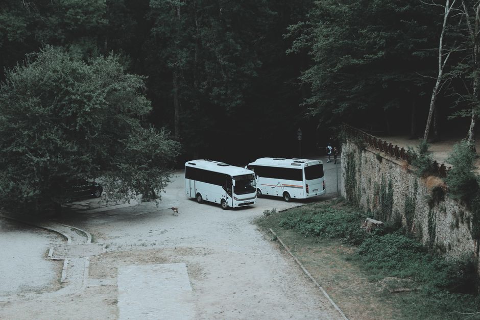 Group of friends laughing and boarding a charter bus for a group trip